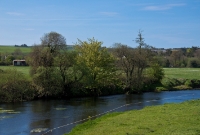 Adjacent to Desert is the Bandon River, where once here the large Desert Woollen Mill stood. The large mill building which featured a water wheel was served by a siding which ran from the goods yard at Desert Station, visible in the distance.