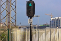 Signal DS (Docklands) No.103 displays a clear aspect for 233 to depart back to Clonsilla. In the background a 29000 Class railcar crosses the line and the Royal Canal into Connolly Station, out of view to the left.