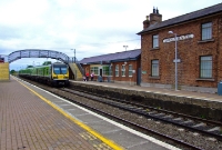 A more recent scene at Donabate Station, showing a 29000 Class railcar arriving with a stopping service from Drogheda to Dublin. The main station buildings, built of brick, are seen in this photo. The Victorian footbridge has since been removed.