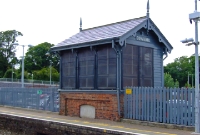 Donabate signal cabin, viewed from the up platform. The cabin retains most of its original features, including its wooden name board. The cabin was taken out of use in 1983 when the signalling block post was abolished. The interior of the cabin still retains its small lever frame.