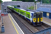 Viewed from the footbridge at Donabate Station, 2600 Class railcar No.2607 coasts into Donabate Station with a northbound service from Drogheda to Dublin. The road overbridge at the south end of the station seen here replaced the original stone built type in early 2003.