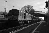 201 Class loco No.209, still in its original 1990s &#39;Enterprise&#39; livery, propels this southbound Belfast to Dublin express through Donabate Station.