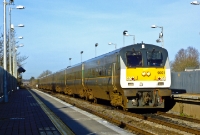 DVT No.9001 leads at speed the midday Belfast to Dublin &#39;Enterprise&#39; express through Donabate Station, propelled by 201 Class loco No.209 (see next photo).