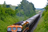 Another 071 Class loco that is partially missing its logo is No.077, still in the older orange &#38; black livery, seen powering the southbound loaded ore train from the Tara Mines.