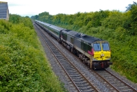 201 Class loco No.207 storms past the residential area of Donabate at the head of the 13:20 Dublin Connolly to Belfast Central &#39;Enterprise&#39; express. No.207 is named &#39;River Boyne&#39;, a throw back to the ex Great Northern&#39;s VS Class steam locomotive which carried the same name and number.