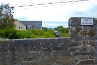 A 29000 Class railcar is seen nearing Donabate Station with a southbound service to Dublin. This overbridge, No.35, gives access to the Beaverstown Golf Club.