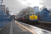 Clearly no luck with the weather on this day, as 071 Class No.081 heads through a rain shower at Donabate with its empty Tara Mines train. New lift shafts for the modern footbridge have already been installed.