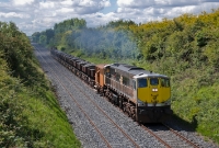 071 Class loco No.079 accelerates on the approach to the bridge at Beaverstown, north of Donabate, with a loaded ballast train from Dublin&#39;s North Wall yard.
