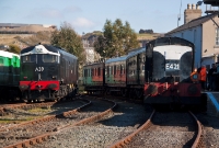 E421 is seen complete with ITG headboard as it prepares to depart with an afternoon special service to Inch Abbey, consisting of a mixed rake of ex Great Southern &#38; Western and CIE stock, while A Class loco No.A39 moves about the yard.