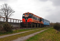 The halt at King Magnus&#39;s grave consists of a single platform. Here 141 Class 146 prepares to depart back to Downpatrick with the railbus RB3. The nearby grave is an ancient burial mound for Magnus Barefoot, a 11th century Viking king.