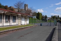 A view from the down platform at Drimoleague, looking east towards Cork, showing the tennis court which occupies part of the station site. The local church located high above the station was rebuilt in 1960/1 shortly before the railway closed, and features prominantly in old photos of the station.