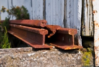 Three rusty forgotten rails remain dumped by the station building at Drimoleague, left behind after closure by CIE of the west Cork railway in March 1961.