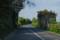 Just south of Drimoleague village on the R593 road to Baltimore, the branch line to Baltimore itself crossed the road on a metal plate overbridge. Today only the stone bridge abutments remain, with the railway embankment having been removed on the northern side.