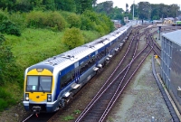 Nowadays the site of the original station is occupied by the diesel railcar depot. This similar view from the road bridge sees Northern Ireland Railway&#39;s Spanish built 3000 Class railcar No.3003 leaving the station on a substituted southbound &#39;Enterprise&#39; from Belfast.