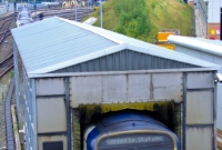 29000 Class No.29114 passes through the washer opposite the railcar depot at the south end of Drogheda. Part of the earth mound which once had spruce trees is visible in the background.