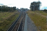 This view of Drogheda is taken from the twin road overbridge south of the station, with the Navan branch visible diverging to the left. On the other side of the earth mound on the right is the site of the original Dublin &#38; Drogheda Station, built in 1844 and replaced by the present station in 1853.
