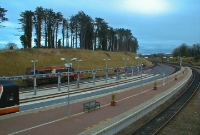 A view looking south towards Dublin from the footbridge at Drogheda Station, looking across to the railcar stabling point. The earth mound and spruce trees would soon be cleared away for the new diesel railcar depot.