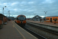 Mk3 push pull driving van trailer No.6103 is seen on the rear of this northbound commuter service to Dundalk. To the right is one of the 2800 Class railcars in its orange &#38; black &#39;Arrow&#39; livery.