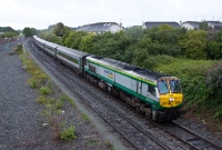 &#39;Intercity&#39; liveried 201 Class loco No.228 approaches Drogheda with a morning Dublin to Belfast &#39;Enterprise&#39; service. No.228 entered service in the original Irish Rail orange livery in April 1995.