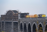 071 Class No.073 has emerged across the steel span section of the Boyne Viaduct at Drogheda with a weed spraying train from Dundalk. Originally built to accommodate double track, the central span, which us under refurbishment, was rebuilt in 1932 to a single track only.
