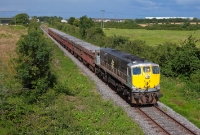 On the outskirts of Drogheda town, 071 Class loco No.082 leads the afternoon empty Tara Mines from Dublin to Navan, seen approaching the M1 motorway bridge.