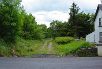 This was the site of the adjacent station level crossing at Dromahair. The trackbed is used a a dirt track, this view is looking west towards Collooney.