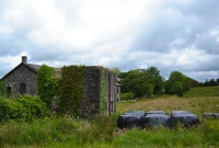 A view looking east towards Enniskillen from what was the end of the platform at Dromahair Station. The station site at the east end is somewhat overgrown. On the left is the stone base of the former signal cabin.