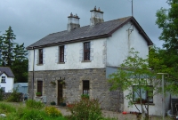 A view of the station building at Dromahair, the second storey was a latter addition, but the station has lost its platform canopy. The trackbed and former single platform is in the foreground.