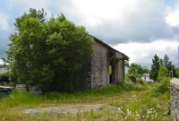 This is the former stone built goods shed at Dromahair Station, which still retains part of its wooden canopy on the road side.