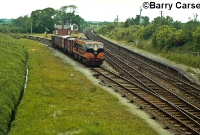 181 Class locos also visited the Ardee branch on goods trains, here No.188 is seen having received a clear signal and is about to join the main Belfast to Dublin line, shortly before the branch closed completely in 1975. In the background can be seen the station building and Great Northern Railway signal cabin. ©Barry Carse