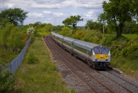 A more recent view of the former Dromin Junction taken in May 2010 sees a southbound &#39;Enterprise&#39; train passing the former up and down platforms. The site of the former station buildings are now fenced off and overgrown.