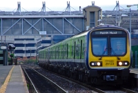 A more mundane scene at Drumcondra Station sees a 29000 Class diesel railcar pauses with a morning commuter service from Dublin to Maynooth. Maynooth is translated in Irish as &#39;Maigh Nuad&#39;.