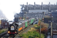 This is a view from the Claude Road footbridge just west of Drumcondra Station, visible in the background. 1947 built ex LMS NCC 2-6-4 tank No.4 leads a Railway Preservation Society of Ireland &#39;Santa&#39; special to Maynooth.