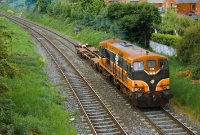 By this time locomotive No.171, dating from 1962, was one of the last 141 locos to remain in service with Irish Rail. It is seen creating a haze of smoke through the Drumcondra area at Claude Rd has it brings a single bogey flat wagon to the North Wall freight yard.