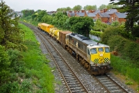 The pioneer 071 Class loco, No.071 in silver &#38; black livery complete with warning placards, approaches the Claude Rd footbridge with Irish Rail&#39;s annual weed spraying train from Dublin to Navan. The chemical can be seen being sprayed towards the rear end of the train.