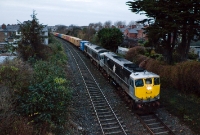 In failing December light, 071 Class loco No.075 has rescued a failed &#39;Enterprise&#39; 201 Class loco No.206 which was working the Ballina to Dublin IWT liner, seen passing Claude Rd footbridge just west of Drumcondra Station.