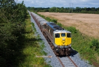 Loco No.080 hauls the midday working from Tara Mines to Dublin Port, seen between Duleek and the former Lougher Halt, the latter also closed in 1958. Much of the Navan branch has been relaid with concrete sleeper track as evident in this view.