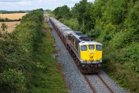 Loco No.086 passes milepost 5½ at the Duleek Roadstone Bridge, measured from the junction at Drogheda, as it leads a the morning laden Tara Mines train to Dublin Port.