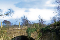 This small river bridge carries the railway line across a  tributary of the River Tolka south of Dunboyne. This was the bridge as it was in 2009, before the line was relaid the following year.