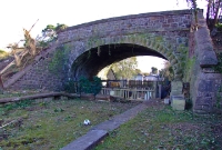 A February 2009 view of the overbridge, which carries the R156 road over the line. Built for the double track up &#38; down lines, the up line at the station latterly became a loop, and then a loop siding until the line closed in 1963.
