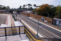 A view looking south towards Dublin from the footbridge at Dunboyne Station. The former Midland Great Western Railway station building can be seen behind the wooden fence. The end ramps of the platforms mark the site of the original MGWR footbridge, but this had long since been removed before the line closed first in April 1963.