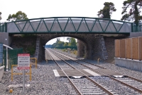 A view of the road overbridge, now with the double track line restored. An additional pedestrian bridge has been built in front of it.