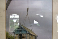 A picture within the small museum at Dundalk Station, showing the removal of the redundant signal cabin in 1996. The cabin was placed on a rail flat truck and hauled up to the platform at the station.