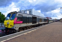 No.233 named &#39;Abhainn na Chlair&#39; or &#39;River Clare&#39;, is seen again at Dundalk Station this time propelling a southbound &#39;Enterprise&#39; to Dublin. The large structure behind the train is the once rail served Harp Brewery.
