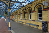 Platform 2 on the down side of Dundalk Station, showing the W.H Mills&#39;s late 19th century yellow brick buildings and cast iron canopies. On the right is the structure housing a very interesting railway museum at the station.