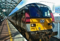 Shadows from the ornage Great Northerl Railway style platform canopies are cast upon &#39;Enterprise&#39; DVT No.9001, seen on a Belfast to Dublin service at Dundalk.