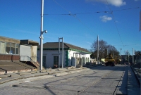 This is the Luas stop at the former Dundrum Station, looking south towards Bray. The the new platforms are at a high level to the original railways ones once sited here. This view was taken before the line opened.