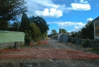 A 2002 view taken at the south end of Dundrum Station, looking towards Bray during the rebuilding of the line. At this time the former railway trackbed had been cleared of vegetation. In the distance the line passes beneath an original stone road overbridge which remains in situ.