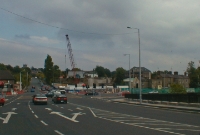 This is a view of the Taney Road before the new Luas line bridge was constructed. In the distance can be seen the station building at Dundrum, located at a higher elevation. The railway line originally approached the station on a embankment on the northside, which had long since been removed.