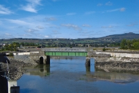 Heading east away from the station at Dungarvan the former railway line crossed the River Colligan on this steel plated bridge. The bridge is seen under restoration conjunction with the conversion of the trackbed into a public footpath.